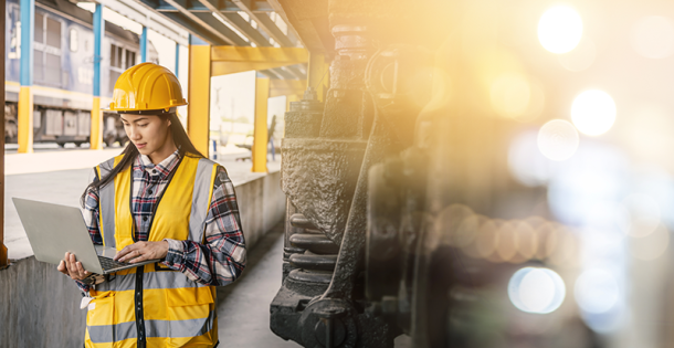 Woman on tablet next to train